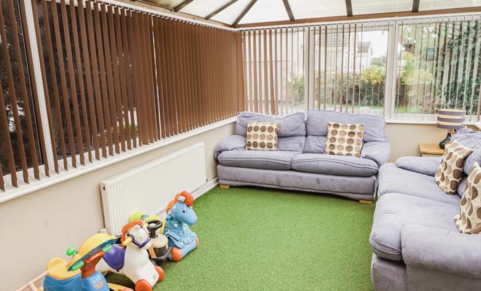 Conservatory leading to outdoor secure play area
